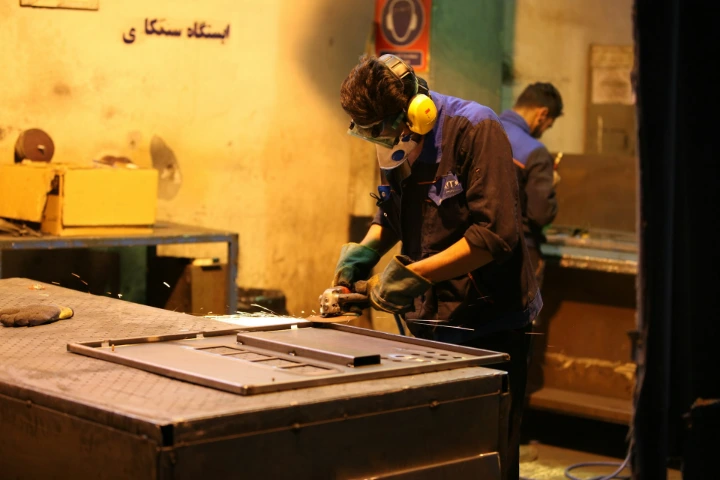 man in blue shirt and green pants wearing yellow helmet